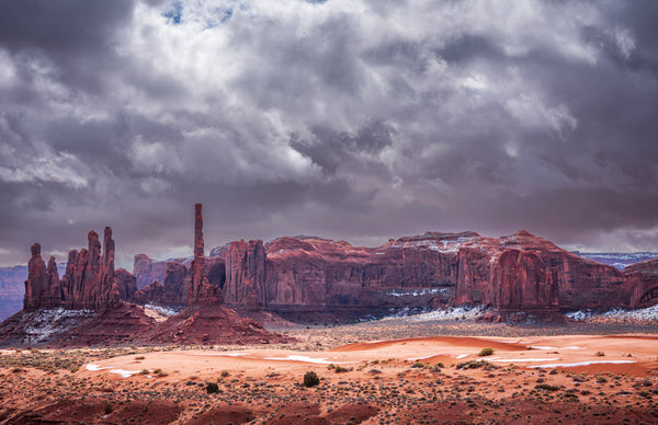 Desert landscape with rock formations under a cloudy sky