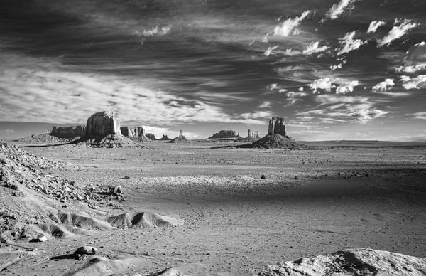Desert landscape with rock formations under a dramatic sky